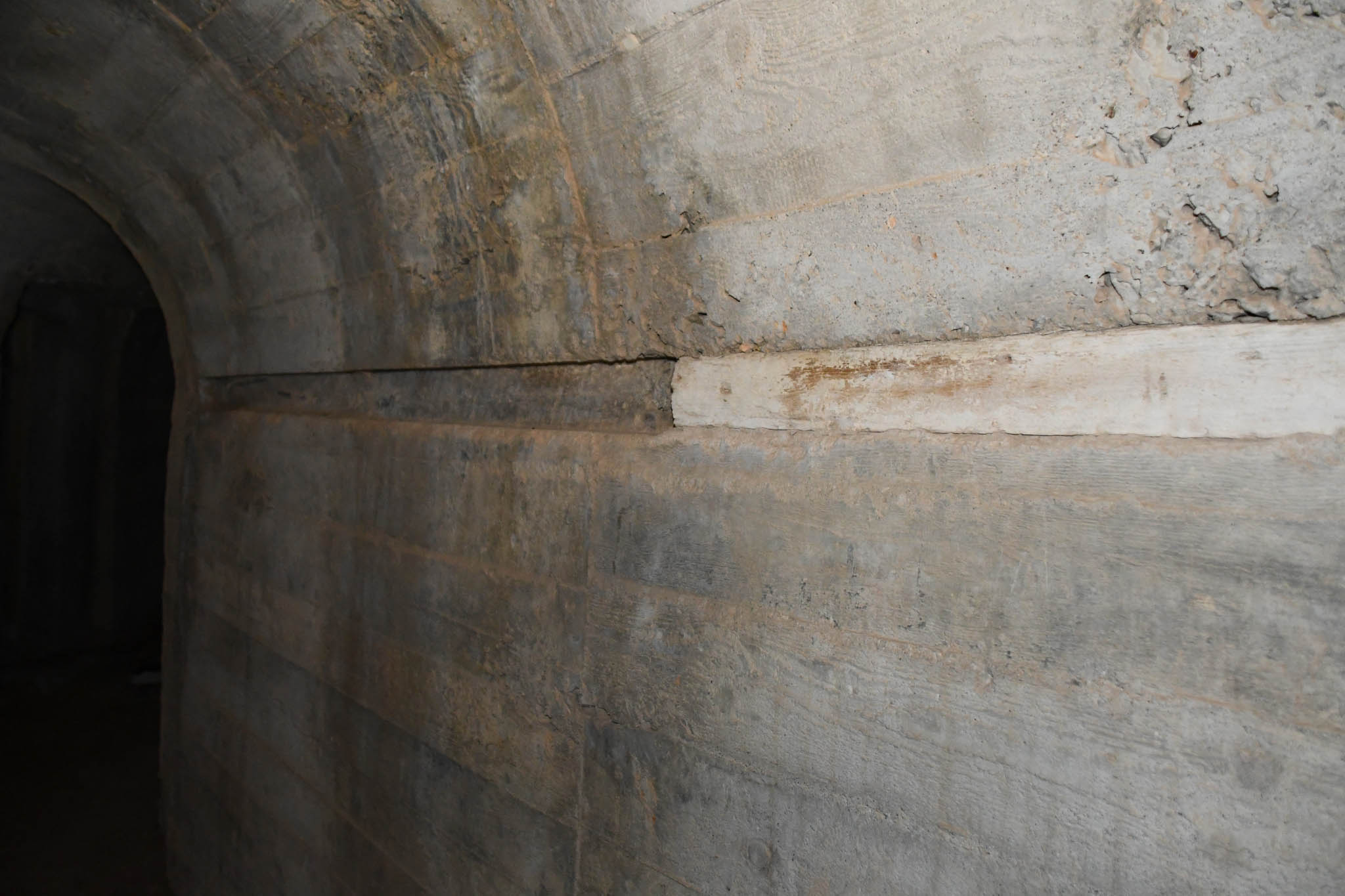 Construction detail - wooden beam embedded in cement